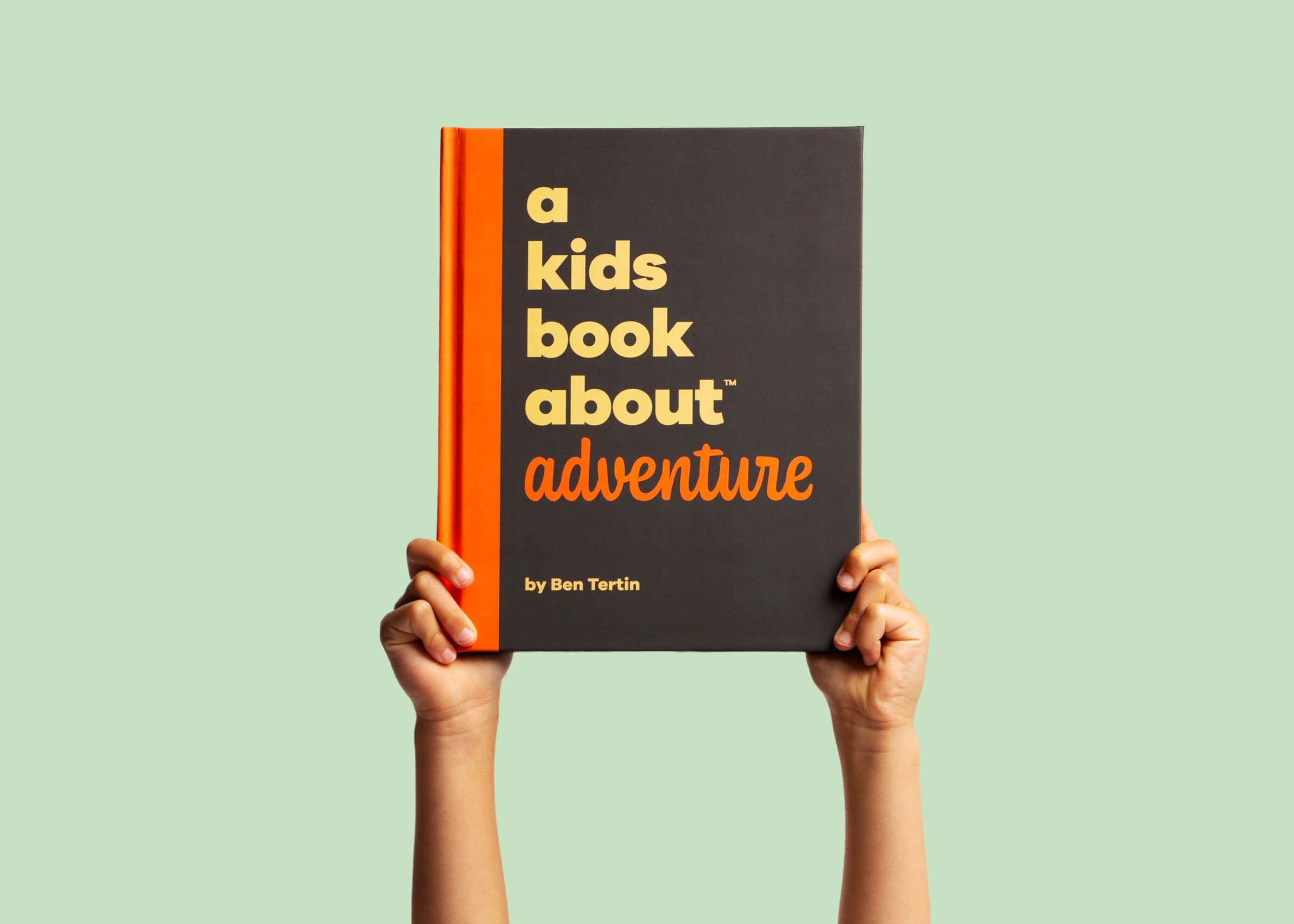 Hands holding A Kids Book About Adventure