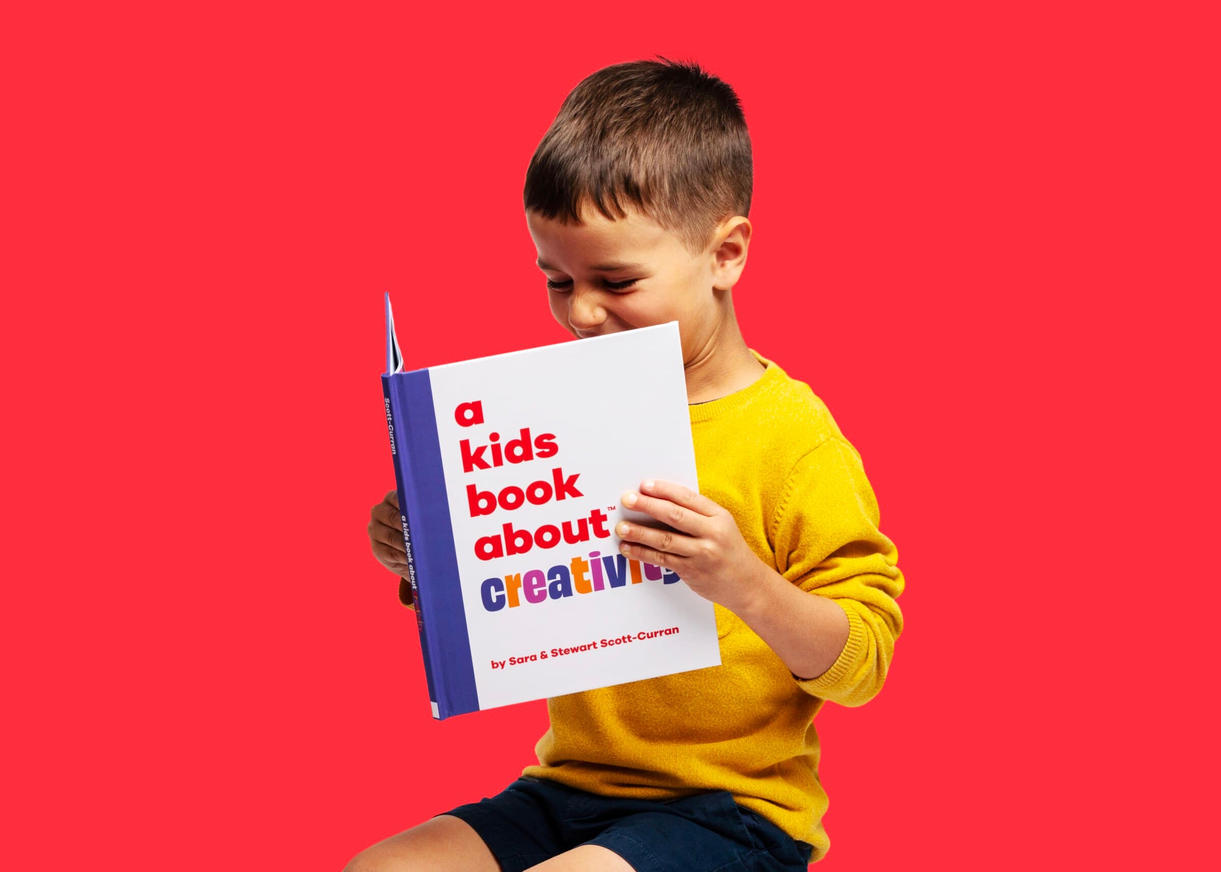 A child holding A Kids Book About Creativity