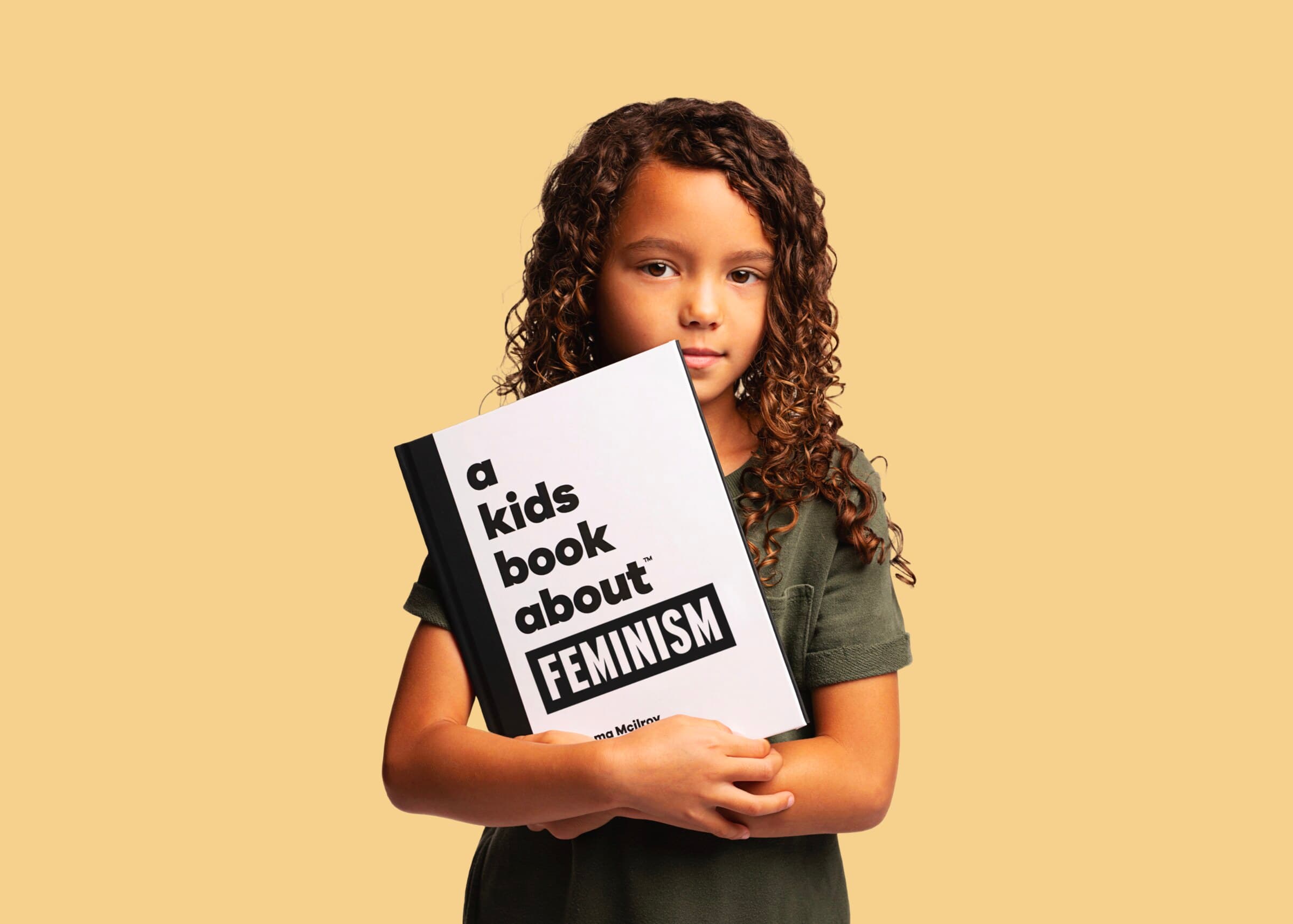 A child holding A Kids Book About Feminism