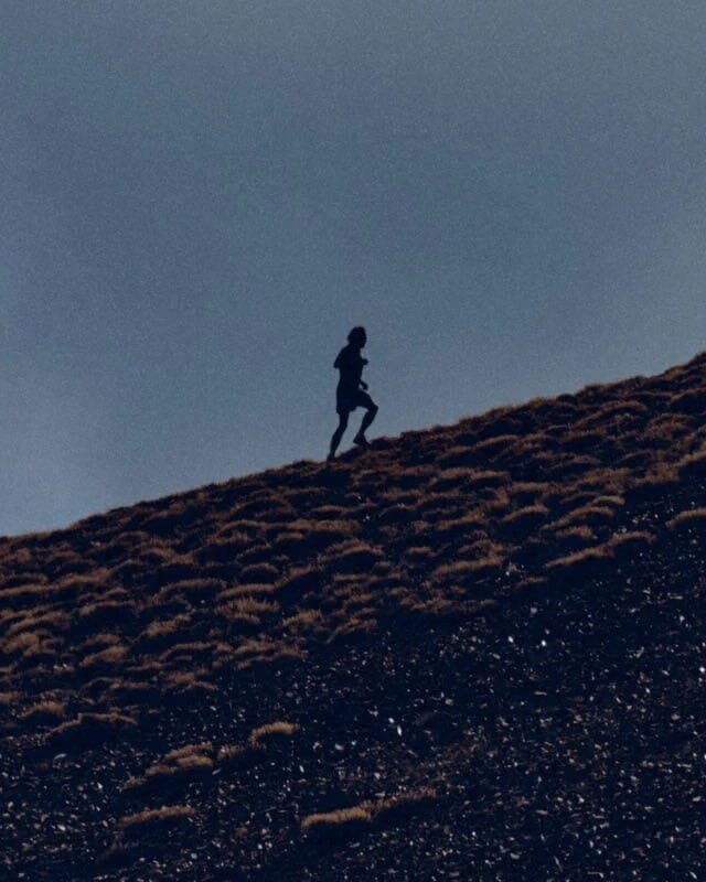 Runner climbing a ridge
